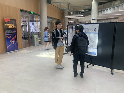 Students looking at poster boards