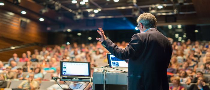 Man presenting infront of a large audience