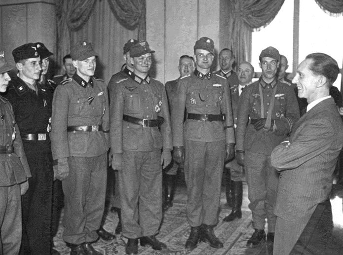 Nazi leader Joseph Goebbels, Reich Minister for Propaganda, talks with Waffen SS and Wehrmacht soldiers he has decorated, March 1944 (Scherl/Sueddeutsche Zeitung Photo)