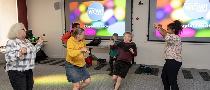 A group of people dance at the Daytime Disco at the Byres Community Hub Day 2024