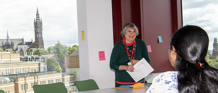 Community group member of our Scribble group hosting a poetry session on level 5 of the Clarice Pears building on our Byres Community Hub Day 2024