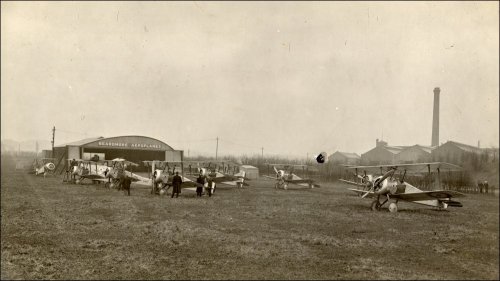 Photograph print, showing eight Sopwith Camel aeroplanes in front of the Beardmore Aeroplanes hangar, built under licence at Dalmuir, Dunbartonshire.  From a William Beardmore & Co Ltd photographic album, c1908-1923.  (GUAS Ref: UGD 100/1/11/8. Copyright reserved.) 