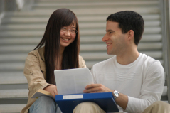 Candid shot of two students chatting on a set of stairs