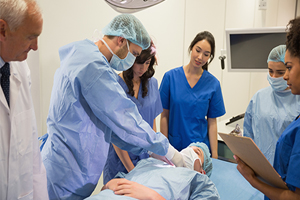 Medical students learning from professor at the university writing in lab