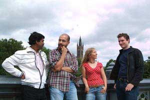 Group of students standing with University tower in background