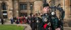 Image of a piper leading a graduation procession