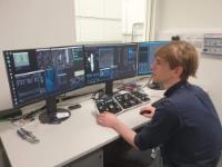 Staff member sat at the controls of the electron microscope