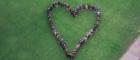 Staff and students stand in the Quadrangles in the shape of a heart