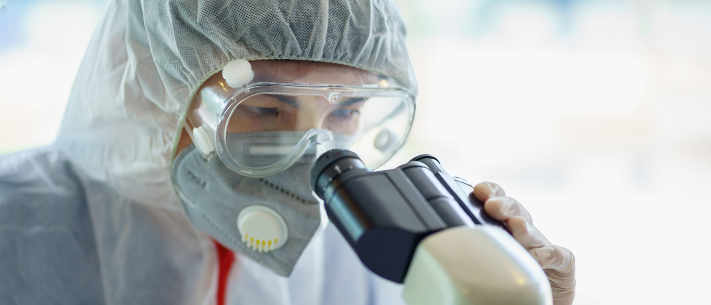 A scientist looking through a microscope in a laboratory [Photo: Shutterstock]