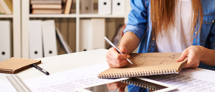 Photo of product designer sitting and drawing at desk