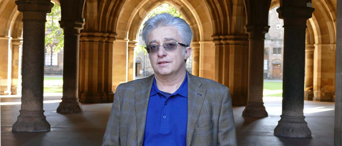 Professor Eugenio Proto standing in front of cloisters