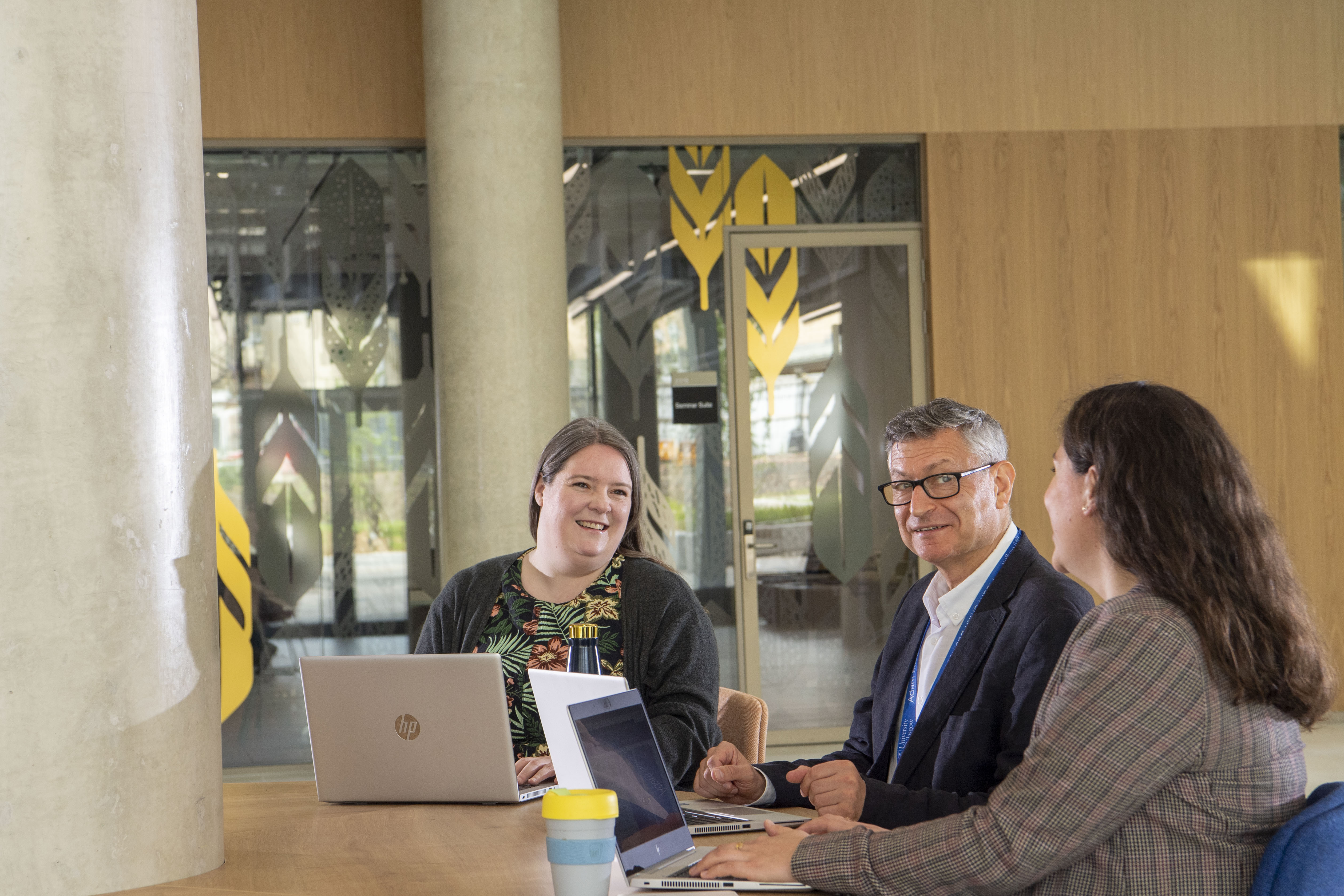 colleagues sitting in discussion at a desk