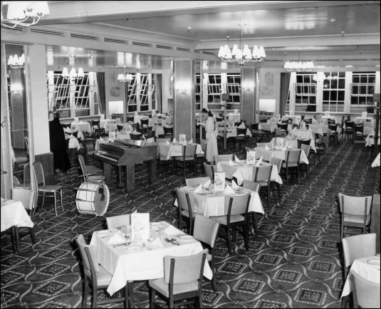 Photograph featuring a waitress preparing tables in the restaurant, c1957.  (GUAS Ref: HF 51/6/1/6/1. Copyright reserved.)