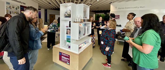 An image of people viewing the Byres Community Hub Tower Exhibition at the launch