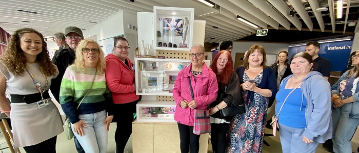 An image of Susan Grant with the Chance2Change group in front of the tower exhibit